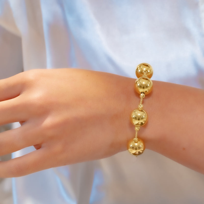 FOUR HUGE SHINNY BALLS GOLD BRACELET