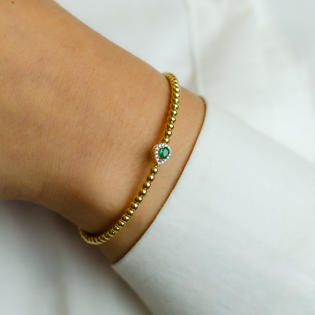 BEADED BANGLE WITH EMERALD PEAR DIAMOND BRACELET