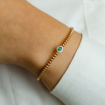 BEADED BANGLE WITH EMERALD PEAR DIAMOND BRACELET