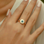 ROUND WHITE & BLUE EYE GOLD RING